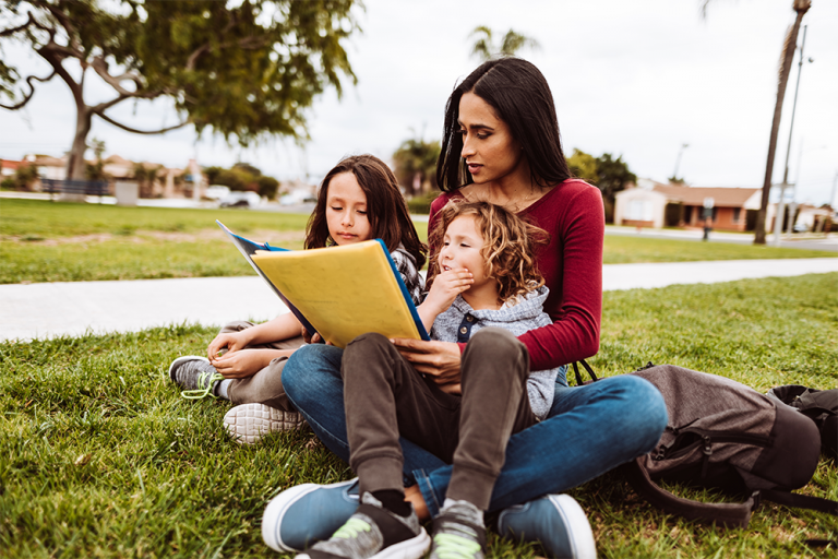 Photo of mother and children reading